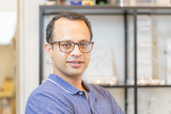 Portrait of handsome man wearing eyeglasses at optical shop, Indian male choosing glasses in optics store Portrait eines Optikers