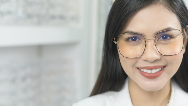 Portrait of ophthalmologist in optical center, eyecare concept. Portrait einer jungen Optikerin